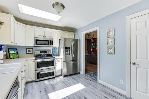 a kitchen with white cabinets and stainless steel appliances at Spacious Home with Deck on Shores of Lake Wylie in York