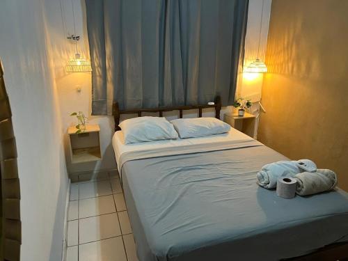 a bedroom with a bed with towels on it at Anana Coliving in Playa del Carmen