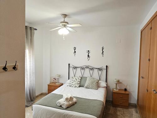 a bedroom with a bed with a teddy bear on it at Romántico apartamento céntrico in Málaga