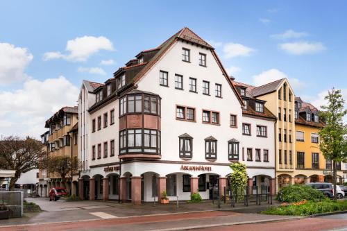 a white building with black windows on a street at ARKADEN Hotel Kelkheim in Kelkheim