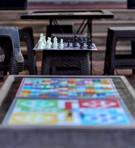 a table with chess pieces on top of it at Hotel Strawberry inn, Mahabaleshwar in Mahabaleshwar