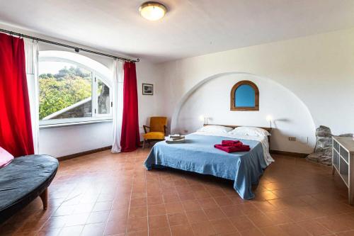 a bedroom with a bed and a large window at La Cantina - ACrapa Mangia in Santa Maria di Castellabate