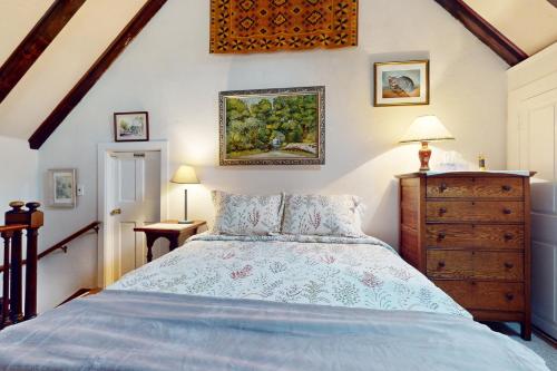 a bedroom with a bed and a painting on the wall at Great Ledges Studio in Rockport