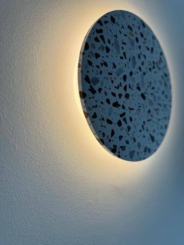 a round hole in a wall with a light on it at Catherine Hotel in Kos Town