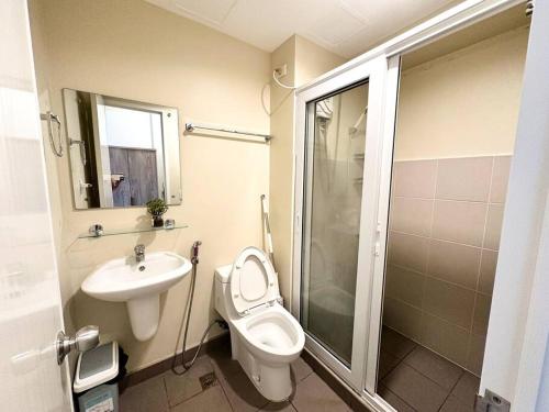 a bathroom with a toilet and a sink and a shower at Heart of CDO Cozy Condo Wi-fi Netflix in Cagayan de Oro