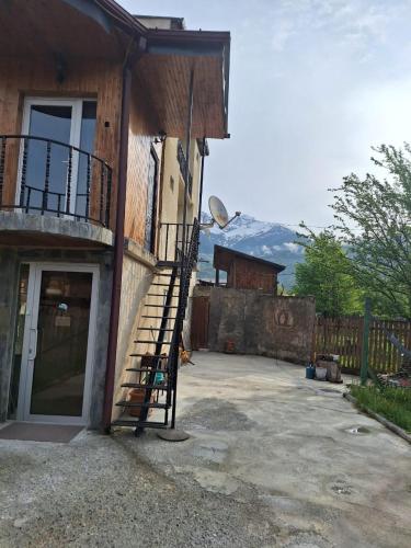 a staircase on the side of a building with a door at Guest House Vanda in Mestia