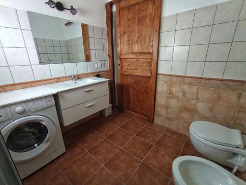a bathroom with a washing machine and a sink at Da Nonno Francesco in Teulada