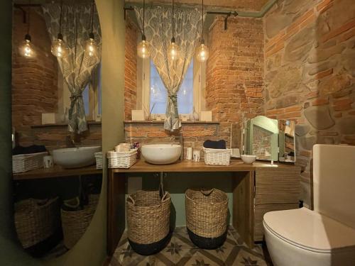 a bathroom with two sinks and a toilet at La Porta Verde in Lucca