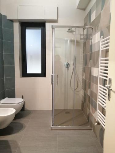 a bathroom with a shower with a toilet and a sink at CASA DIDYMA in San Giovanni Gemini