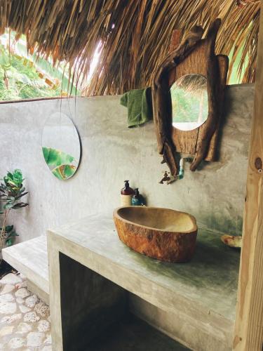 a bathroom with a wooden sink on a counter at Agua de Luna in Isla Fuerte