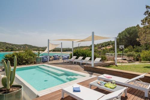 a villa with a swimming pool and a patio at Villa SEA SOUL - Luxury style with direct access to sea in Porto Taverna