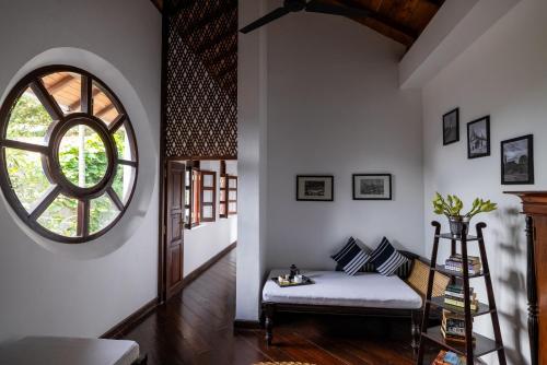 a living room with a bench and a large window at Seven Pillars No 39 Galle Fort in Galle