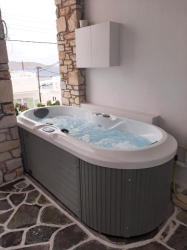 a jacuzzi tub in a room at studios FLORA in naoussa paros in Naousa