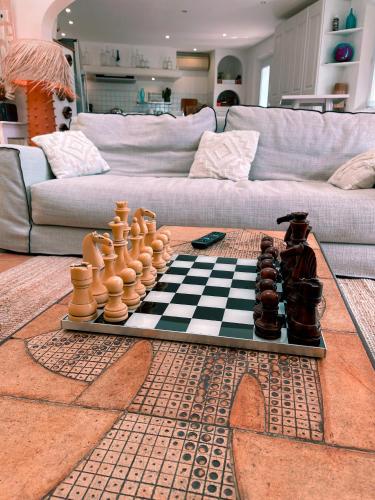 a chess board and chess pieces on a checkerboard at Villa provençale Golfe St Tropez climatisée piscine chauffée, Spa, billard, Wifi haut débit pro in Gassin