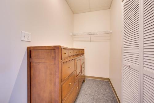 a closet with a wooden cabinet in a room at Conference Center and Pond New Kensington Apartment in New Kensington