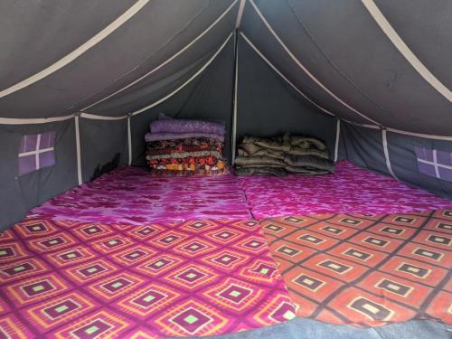 a tent with a bed in the middle of it at NamasteNomads X Musafirokibasti in Kedārnāth