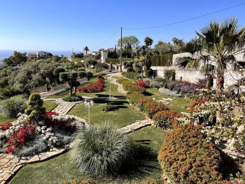 a garden with colorful flowers and plants at Villa Puerto de la Luz in Mijas