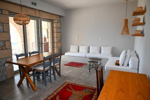 a living room with a white couch and a table at Athina's Stone House in Kardamyli in Kardamili