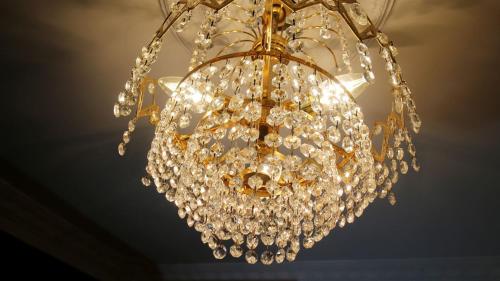 a large chandelier hanging from a ceiling at Windsor Residence in Nuwara Eliya