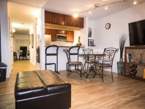 a living room with a table and chairs and a kitchen at Huge 1 Bedroom in Heart of Kihei in Kihei