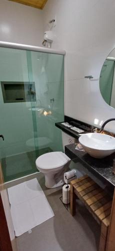 a bathroom with a shower and a toilet and a sink at Pepalantus Flats in Santana do Riacho