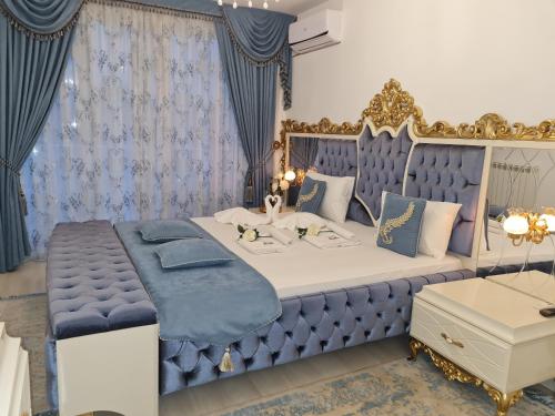 a blue and white bedroom with a bed with a blue and gold canopy at Hotel Dalia - Bankya in Bankya