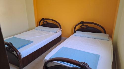 two beds in a small room withermottermott at 2 Bedroom Chalet, Private Garden Ain El Sokhna in Ain Sokhna
