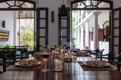a table in a restaurant with glasses of wine at Seven Pillars No 39 Galle Fort in Galle