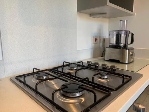 a stove top oven sitting on top of a kitchen counter at Luxury Furnished 2 Bed Northampton apartment with Balcony near NN5 stadium in Upton