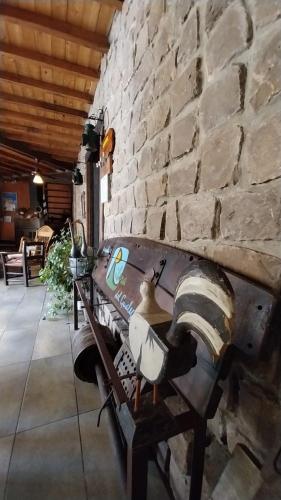 a stone wall with a bench in a room at Posada Ribera del Gualeguaychu in Gualeguaychú