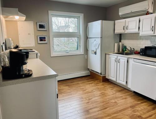 a kitchen with white appliances and a white refrigerator at Comfy 2-BDRM, Historic North End in Halifax