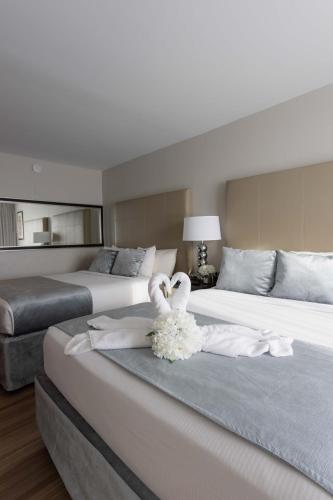 two swans sitting on a bed in a bedroom at Magic Moment Resort and Kids Club in Kissimmee
