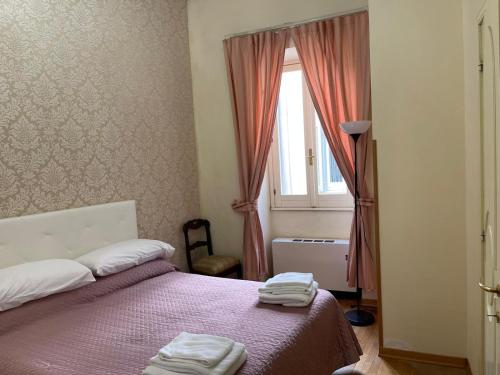 - une chambre avec un lit et 2 serviettes dans l'établissement Suites in Rome 2, à Rome