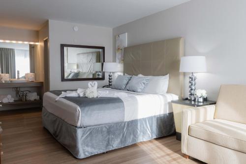 a bedroom with a large bed and a chair at Magic Moment Resort and Kids Club in Kissimmee