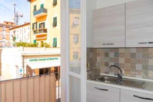 a kitchen with a sink and a view of a building at Appartamento Al Mare in Portoferraio