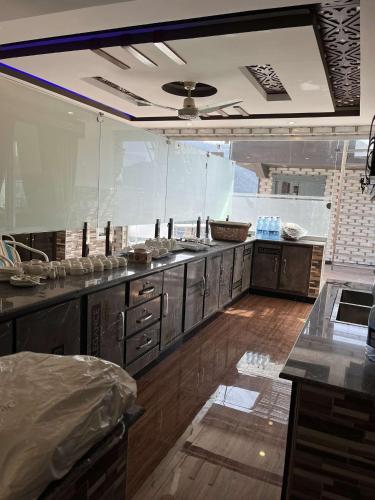 a large kitchen with wooden floors and stainless steel appliances at Areesh Hotel & Restaurant in Lower Topa
