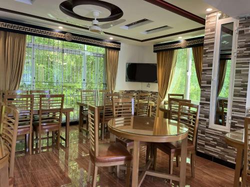einen Konferenzraum mit Tischen und Stühlen und einem TV in der Unterkunft Areesh Hotel & Restaurant in Lower Topa