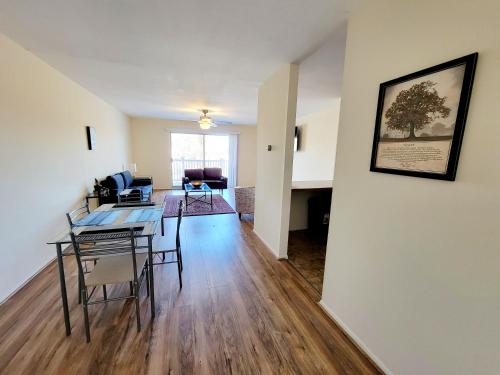 a dining room and living room with a table and chairs at Amazing 2 Bedroom 2 Bath Condo in Elkins Park