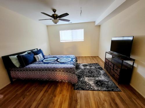a bedroom with a bed and a ceiling fan at Amazing 2 Bedroom 2 Bath Condo in Elkins Park