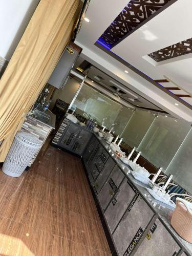 a restaurant with a bar with a counter top at Areesh Hotel & Restaurant in Lower Topa