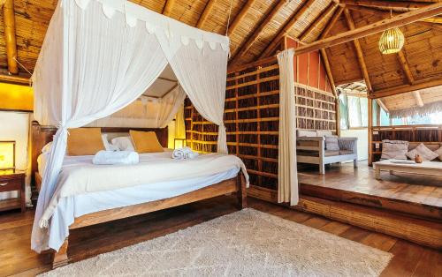 a bedroom with a canopy bed in a room at La Maison Eco House & Yoga in Máncora