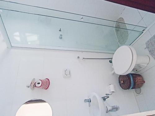 a bathroom with a toilet and a mirror at Casa Dos Artistas in Penedo