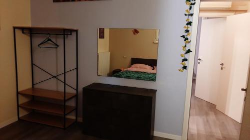 a mirror on a wall with a bed in a room at CASA MARIA1 in Cigole
