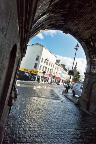 an archway on a brick street in a city at Walled City Apartments in Derry Londonderry