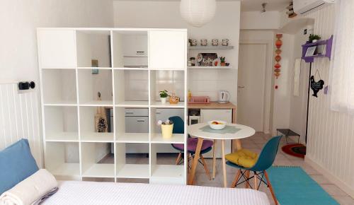 a room with a table and a white book shelf at Apartment Zlatko in Šibenik