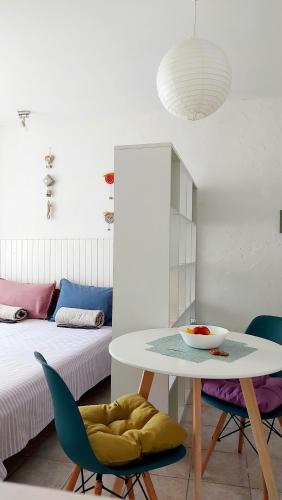 a room with a table and chairs and a bed at Apartment Zlatko in Šibenik
