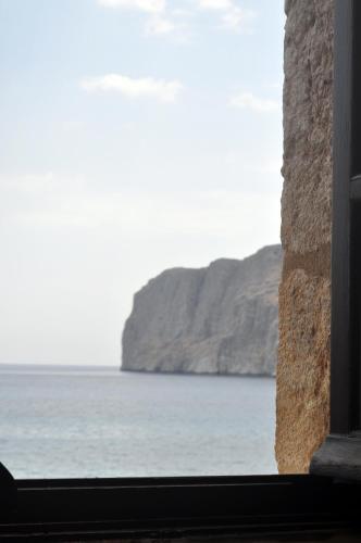 a view of the ocean from a window at Pyrgoi Theodorakaki: O Gerolimenas in Gerolimenas
