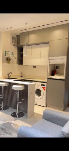 a kitchen with a washing machine and a washer at Nizwa Sky in Nizwa