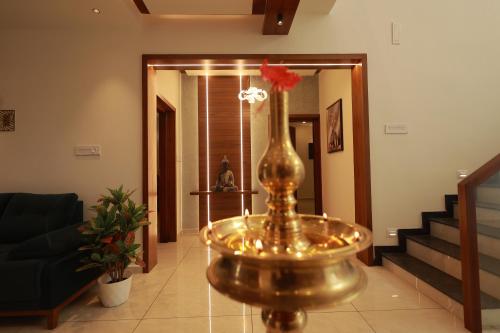 a living room with a vase with a flower in it at Tatvaura Resort Wayanad in Padinjarathara