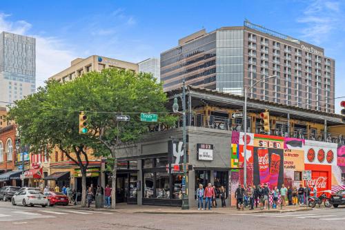 a busy city street with a building on the corner at Littlefield Lofts, Hosted by Placemakr - 6th St in Austin
